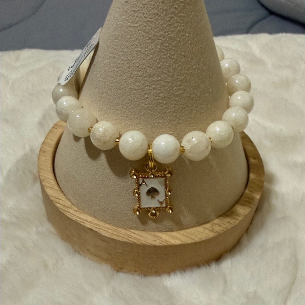 Elegant White Quartz 8mm beaded bracelet with Gold Tone Charm.